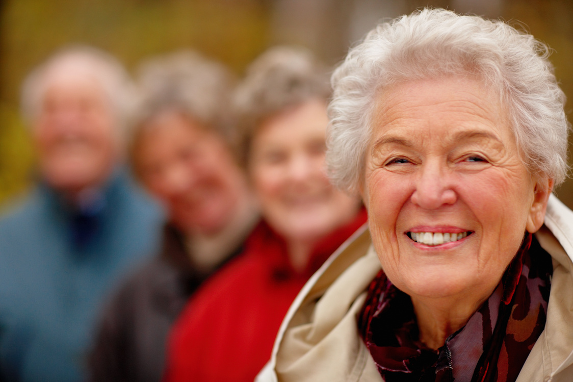 Friendly older woman with group of friends